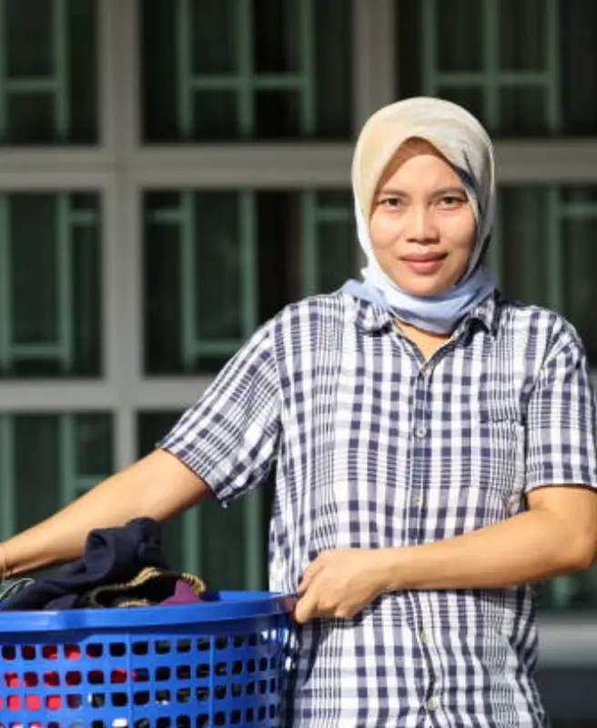Legally recruited Indonesian maid in Malaysia providing elderly and childcare assistance